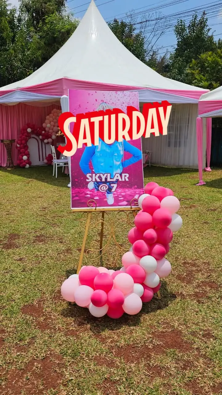 A pink and white party tent with a birthday welcome board and balloon cluster at Vipe Fun Park
