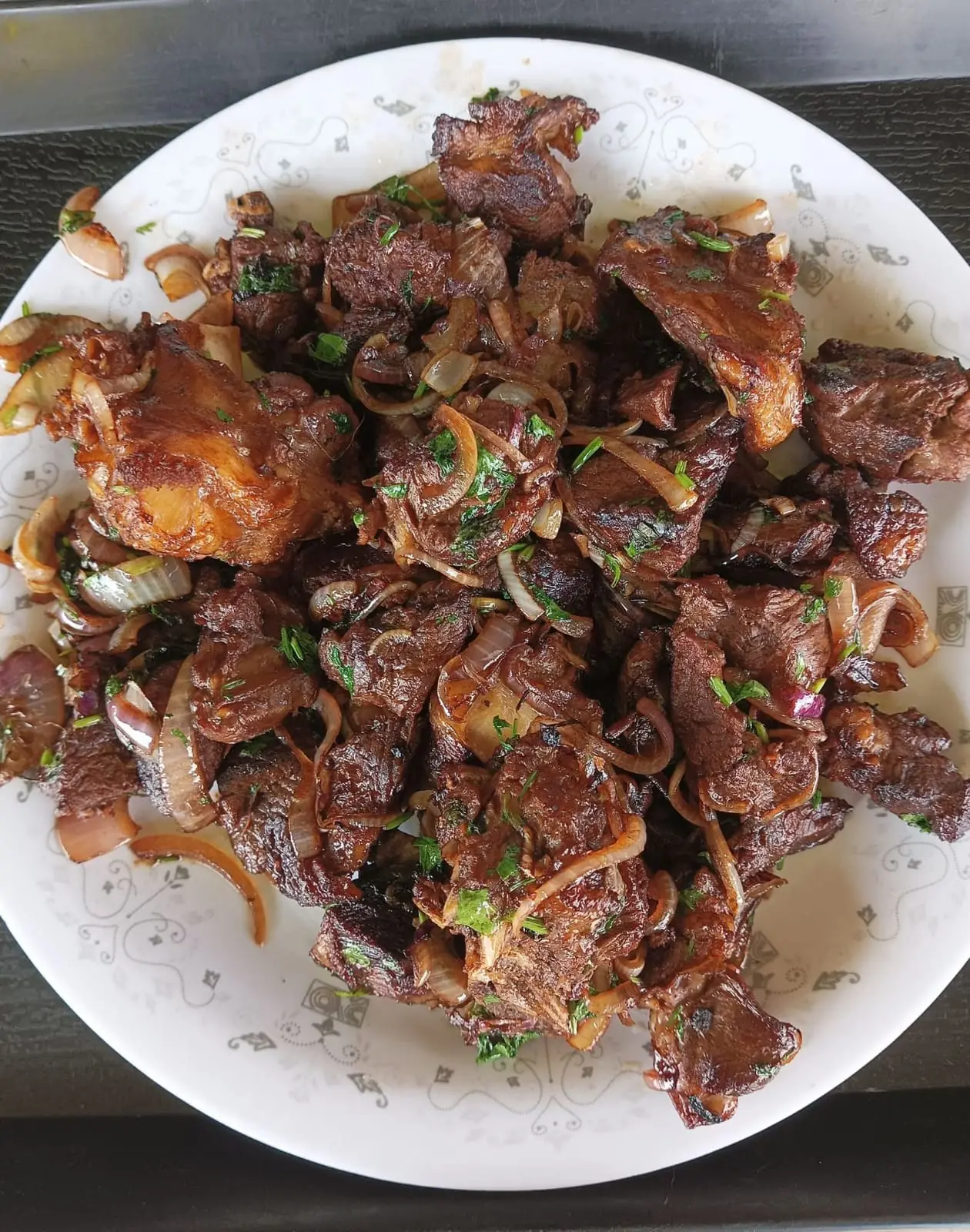 A plate of fried beef with onions and coriander served at Vipe Fun Park