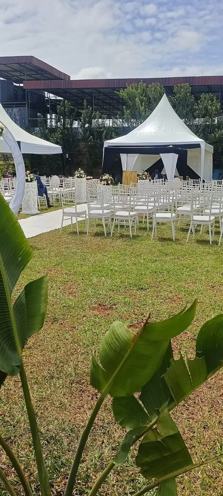 Rows of white chairs and a marquee tent set up for an outdoor celebration at Vipe Fun Park