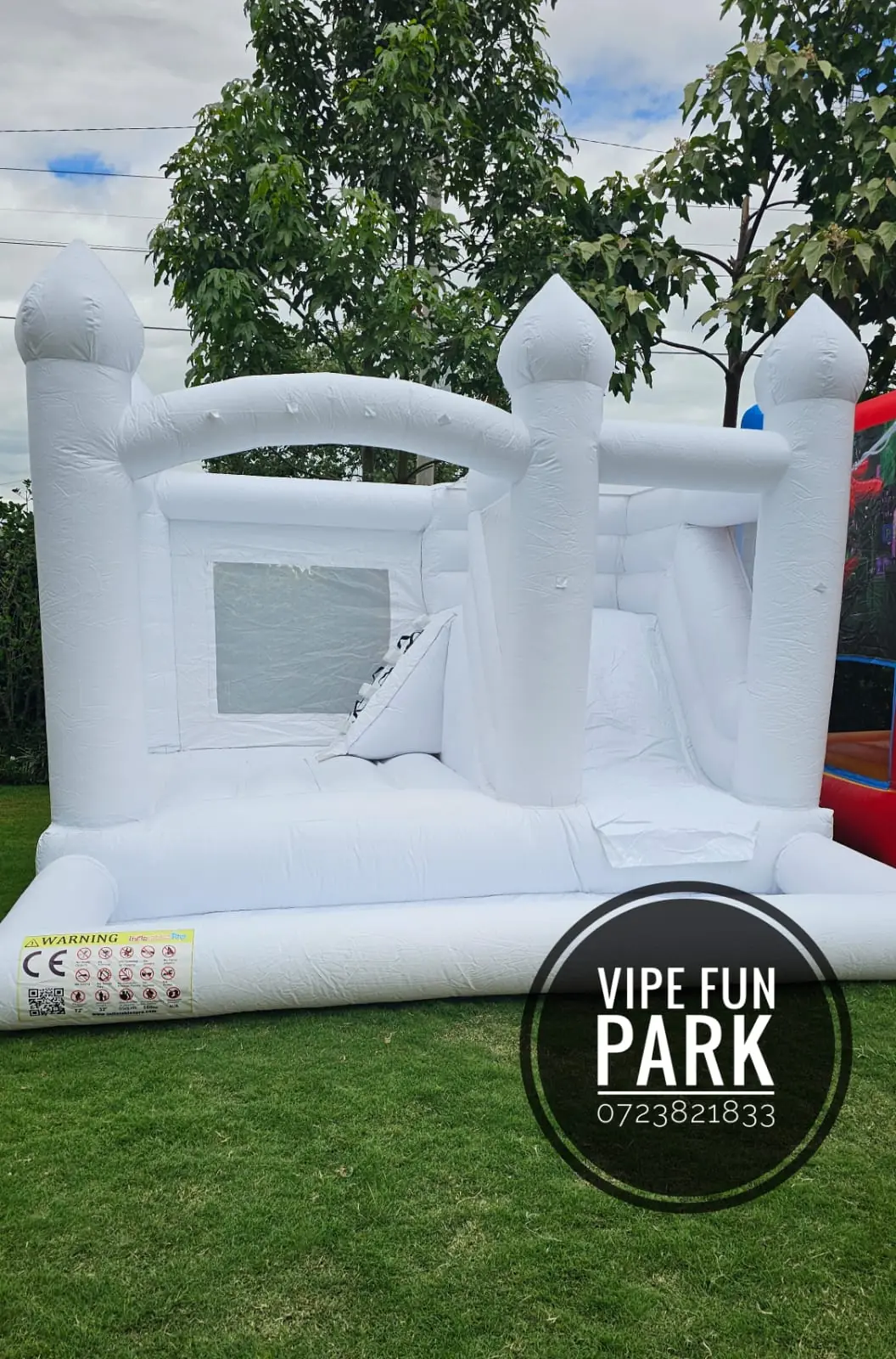 A white bouncing castle with an interior climbing section and slide at Vipe Fun Park